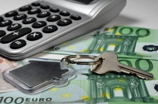 17321891 - calculator, money and house key, shallow depth of field