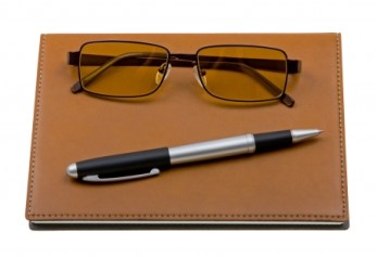 4784727 - daily planner with glasses and pen isolated on white background